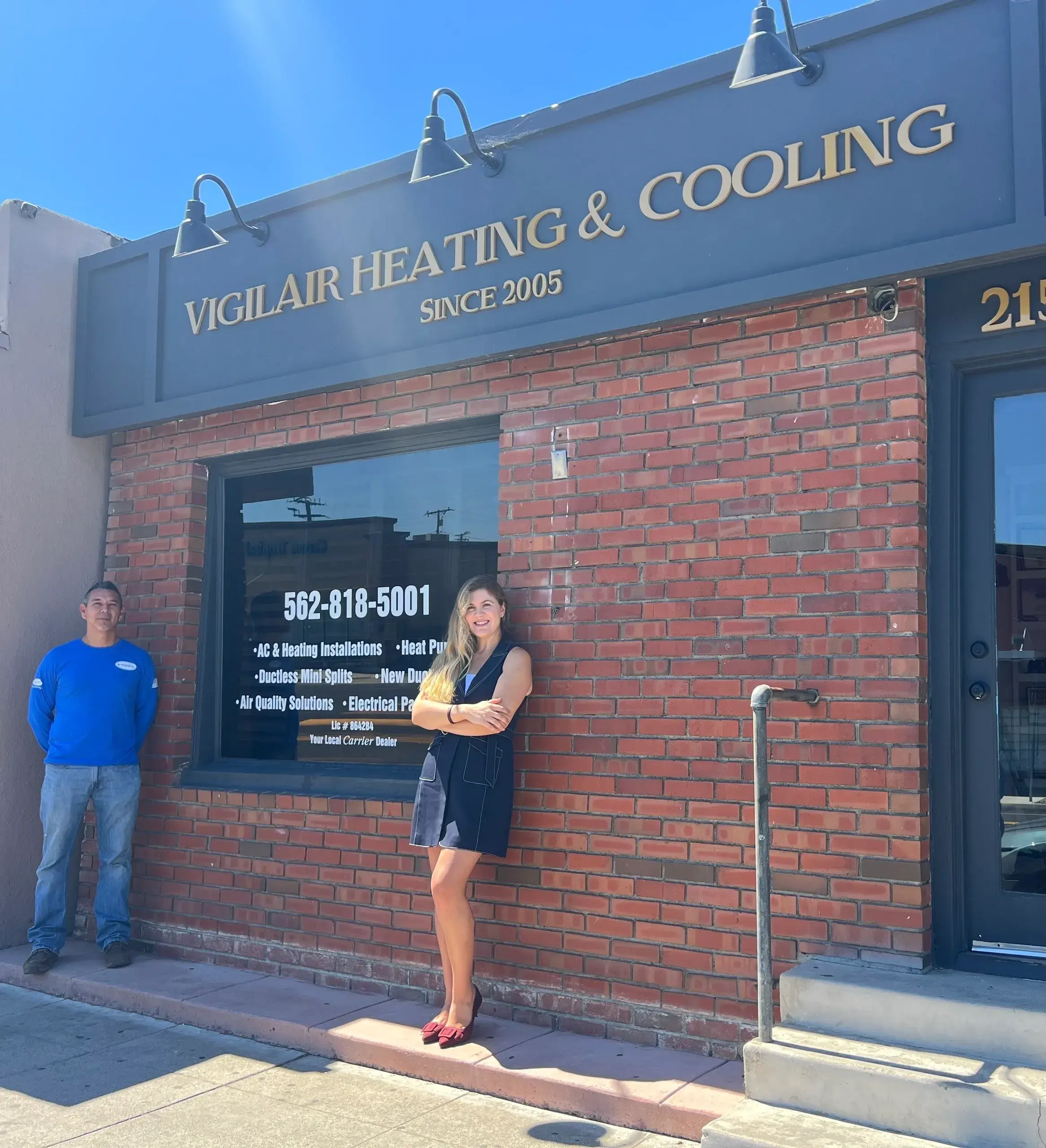 Two people outside Vigilair Heating and Cooling